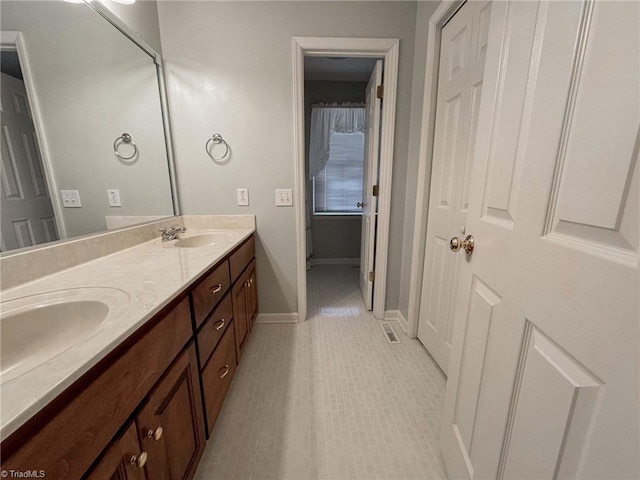 bathroom with tile patterned flooring and vanity