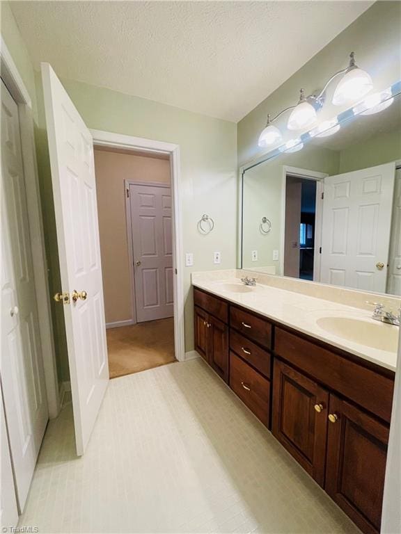 bathroom with vanity and a textured ceiling