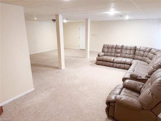 living room featuring a drop ceiling and carpet flooring