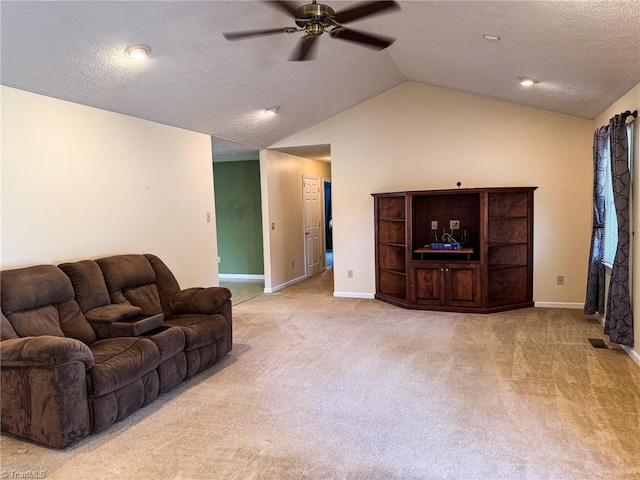 carpeted living room featuring vaulted ceiling, a textured ceiling, and ceiling fan