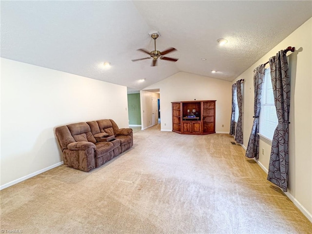 living room with lofted ceiling, light carpet, a textured ceiling, and ceiling fan