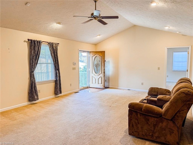 carpeted living room featuring vaulted ceiling, a textured ceiling, and ceiling fan