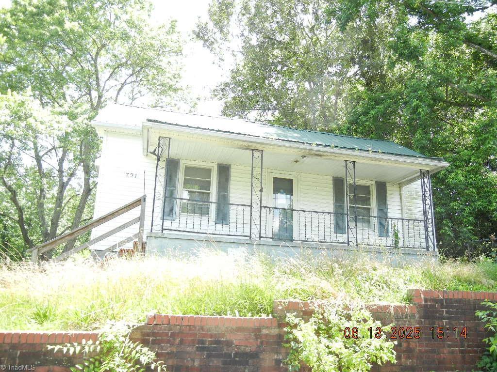 721 Davis St, Eden, NC 27288 - view of front facade featuring a porch and a metal roof