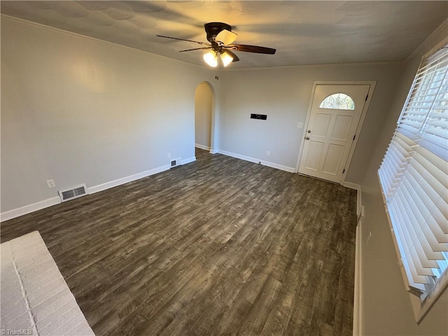 foyer entrance with dark hardwood / wood-style floors, ceiling fan, and crown molding