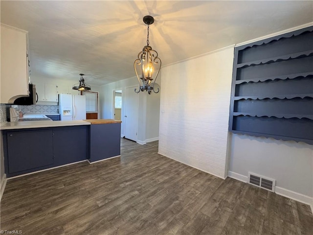 kitchen with decorative backsplash, white refrigerator with ice dispenser, decorative light fixtures, dark hardwood / wood-style floors, and white cabinetry