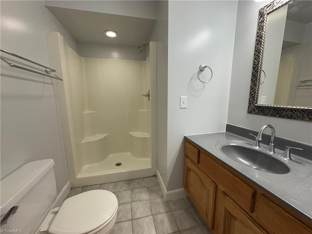 bathroom featuring tile patterned flooring, toilet, a shower, and vanity