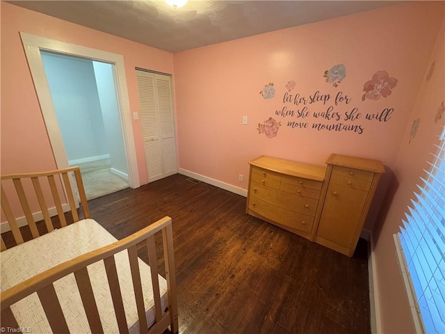 bedroom featuring dark hardwood / wood-style flooring and a closet