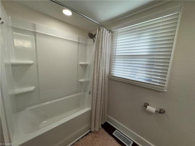 bathroom featuring shower / bath combo with shower curtain