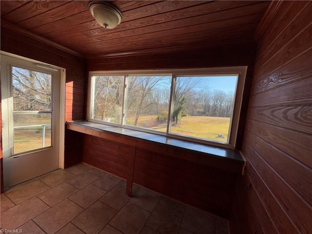 unfurnished sunroom featuring a healthy amount of sunlight and wood ceiling