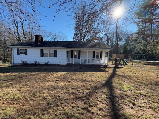 view of front of house featuring a porch, a playground, and a front lawn