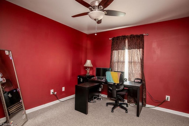 office area with a ceiling fan, baseboards, and carpet flooring