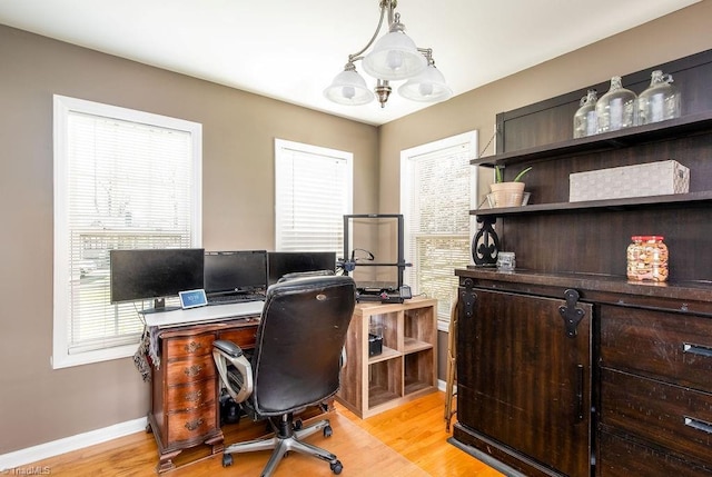 office area featuring light wood-style flooring and baseboards