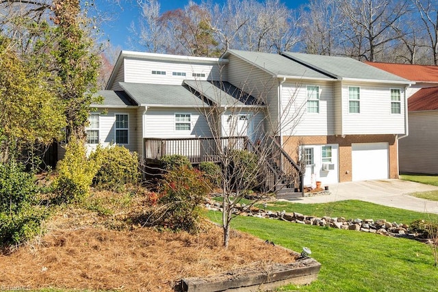 view of front facade with brick siding, an attached garage, cooling unit, driveway, and a front lawn