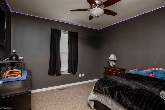 carpeted bedroom featuring baseboards, visible vents, and ceiling fan