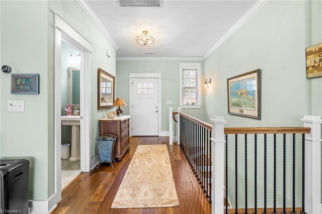 foyer entrance with dark wood-type flooring and ornamental molding