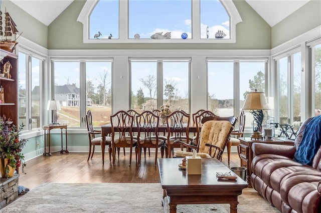 sunroom / solarium featuring vaulted ceiling and a wealth of natural light