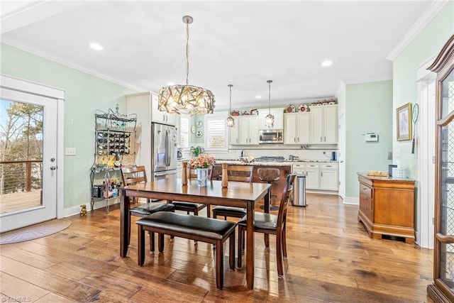 dining area featuring crown molding and hardwood / wood-style floors