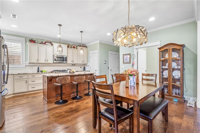 dining space featuring crown molding and dark hardwood / wood-style floors