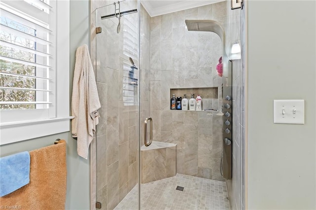 bathroom featuring crown molding and a shower with shower door