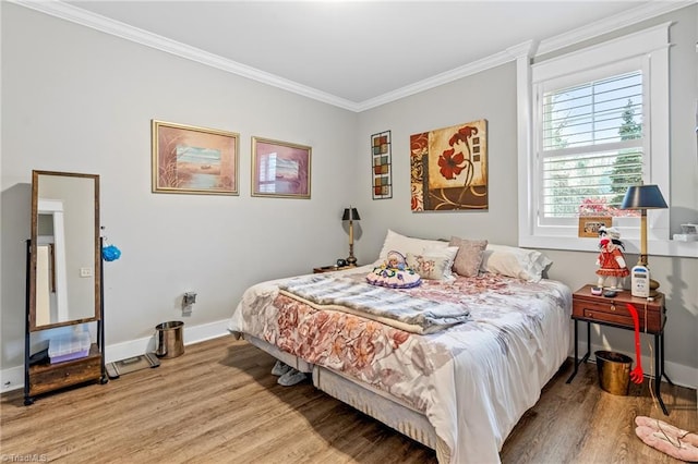 bedroom featuring ornamental molding and light wood-type flooring