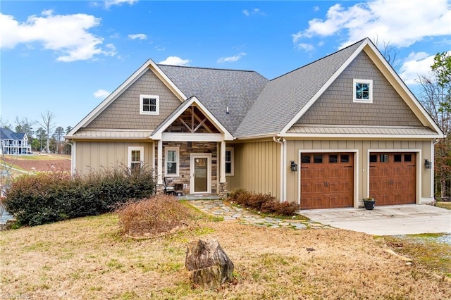 craftsman inspired home featuring a garage and a front yard