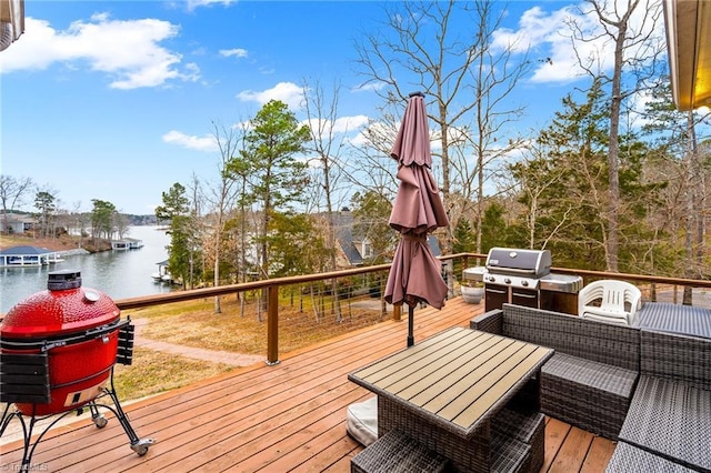 wooden terrace featuring grilling area and a water view