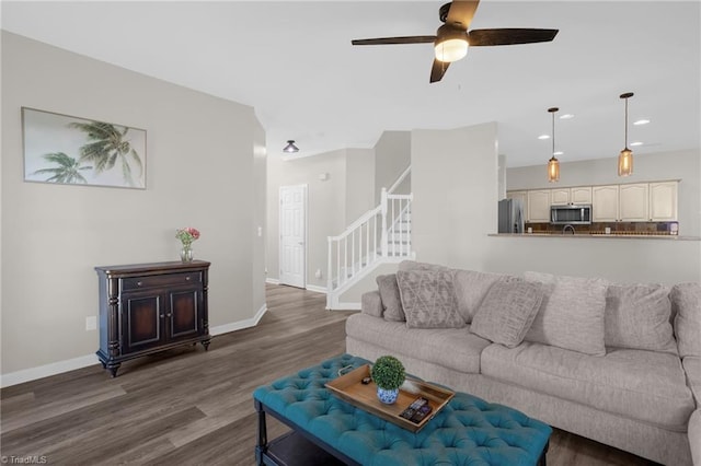 living room with recessed lighting, stairs, baseboards, and wood finished floors