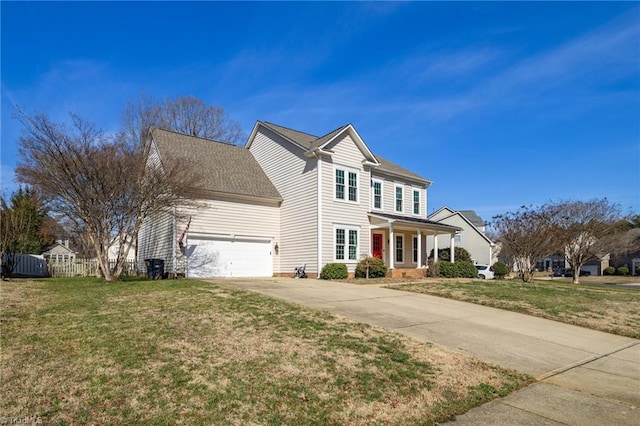 view of front of property with an attached garage, concrete driveway, a front lawn, and fence