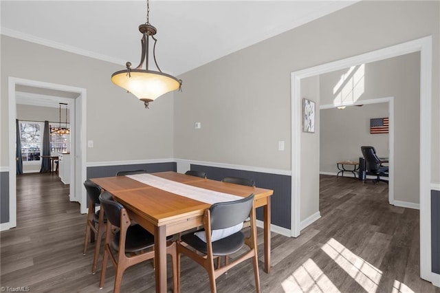 dining room with ornamental molding and wood finished floors