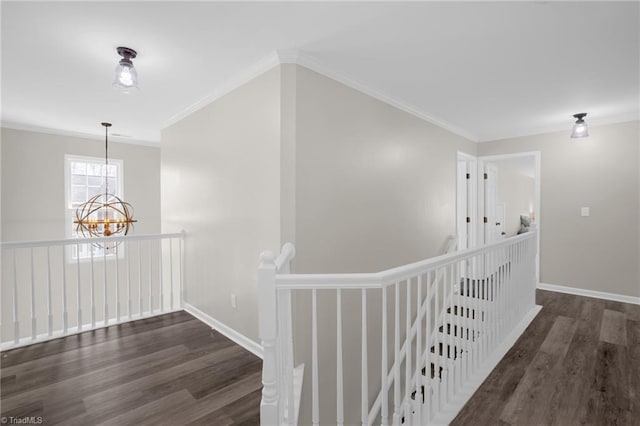 hallway featuring an upstairs landing, crown molding, and wood finished floors