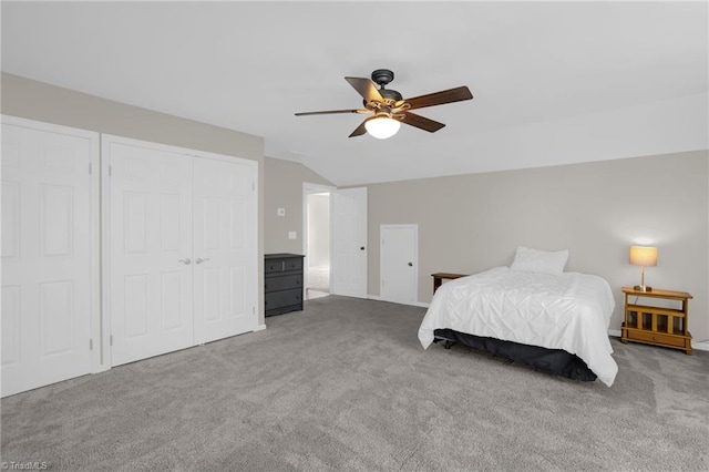 unfurnished bedroom with a closet, ceiling fan, lofted ceiling, and carpet