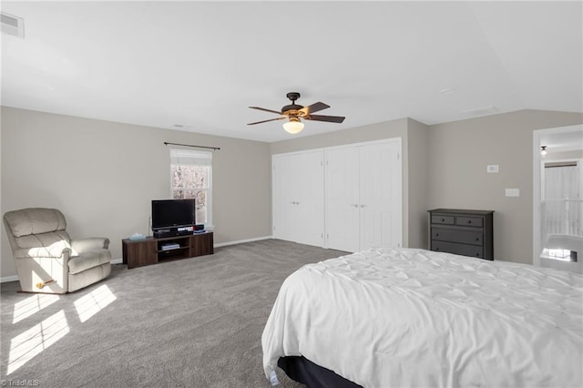 bedroom featuring visible vents, ceiling fan, vaulted ceiling, a closet, and carpet flooring