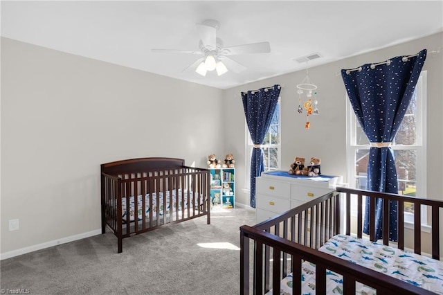carpeted bedroom with baseboards, visible vents, and ceiling fan