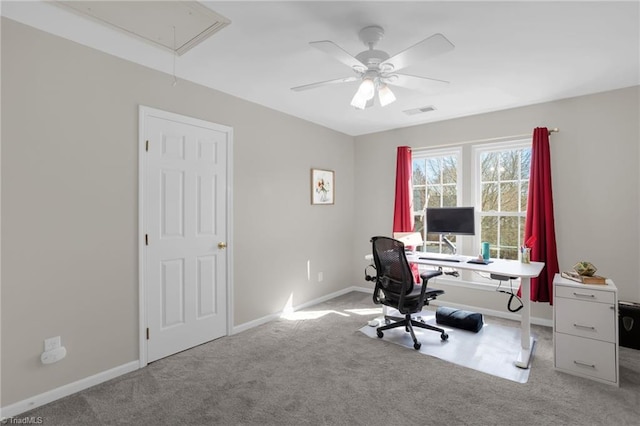 home office featuring visible vents, a ceiling fan, carpet, baseboards, and attic access