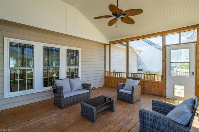 sunroom featuring a ceiling fan and vaulted ceiling