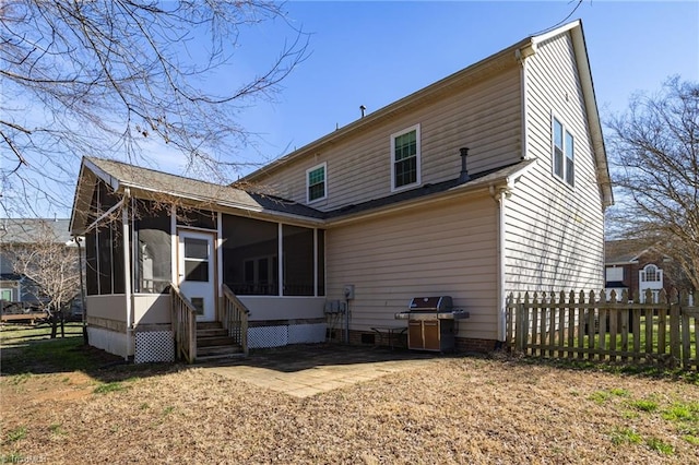 rear view of property featuring fence and a sunroom