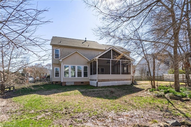 rear view of house with a yard, fence, a sunroom, and crawl space
