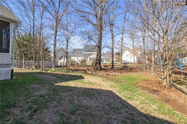 view of yard featuring fence and a sunroom