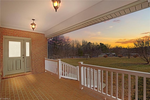 deck at dusk with a lawn