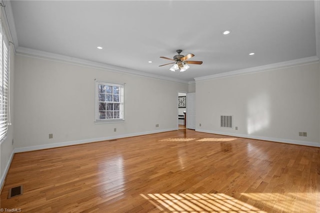 spare room featuring light hardwood / wood-style flooring, ornamental molding, and ceiling fan