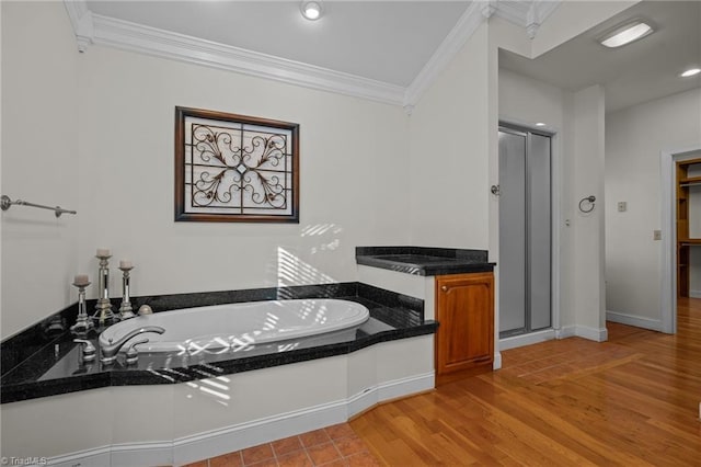 bathroom featuring wood-type flooring, ornamental molding, and plus walk in shower