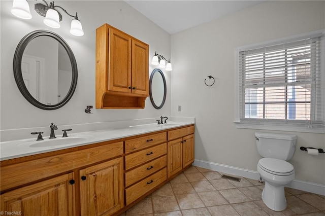 bathroom with vanity, tile patterned floors, and toilet