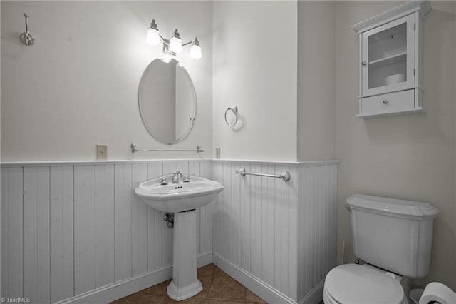 bathroom featuring toilet and tile patterned flooring