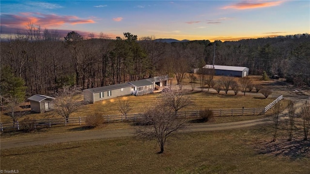 aerial view at dusk featuring a rural view