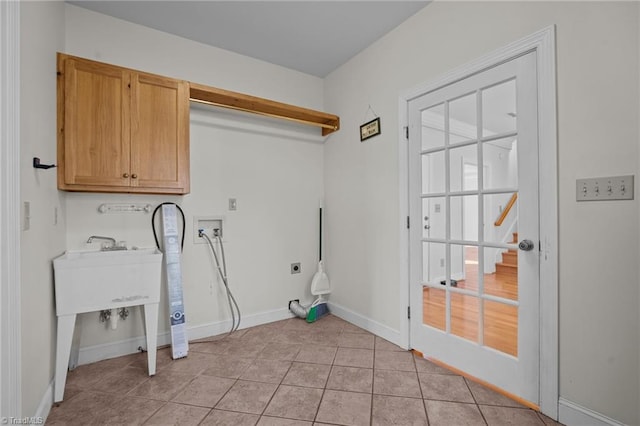 laundry room featuring cabinets, electric dryer hookup, washer hookup, and light tile patterned floors