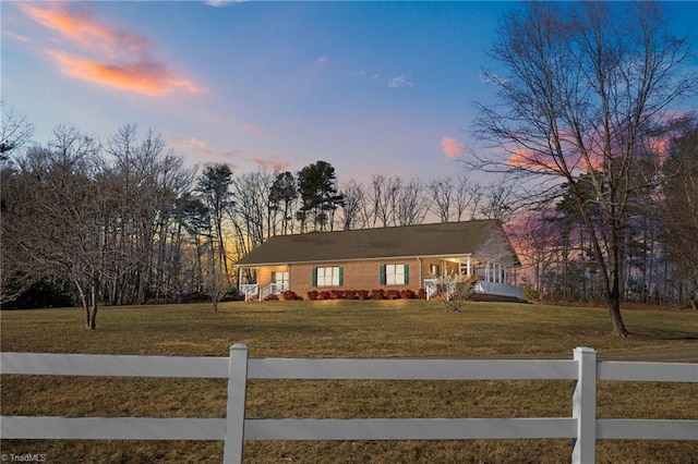 ranch-style house with a lawn