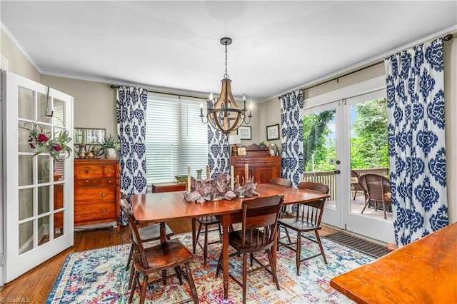2065 Craig St, Winston-Salem, NC 27103 - dining area featuring french doors, a chandelier, crown molding, and wood finished floors