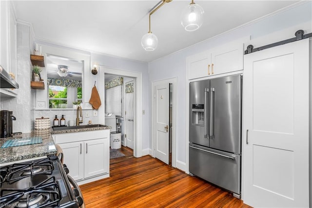2065 Craig St, Winston-Salem, NC 27103 - kitchen with high end fridge, dark wood-style floors, gas range oven, white cabinets, and ornamental molding