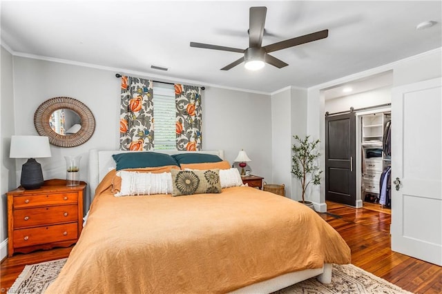 2065 Craig St, Winston-Salem, NC 27103 - bedroom featuring dark wood-style flooring, a barn door, crown molding, and a ceiling fan