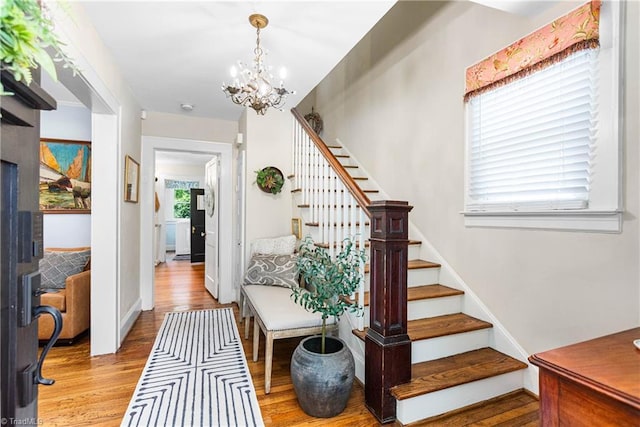 2065 Craig St, Winston-Salem, NC 27103 - staircase with wood finished floors and a chandelier